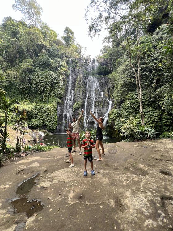 Real photo: the family cheering in front of a waterfall