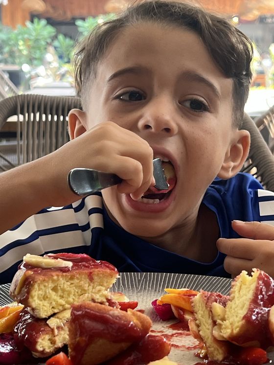 Cody taking a giant bite of pancakes, the real photo